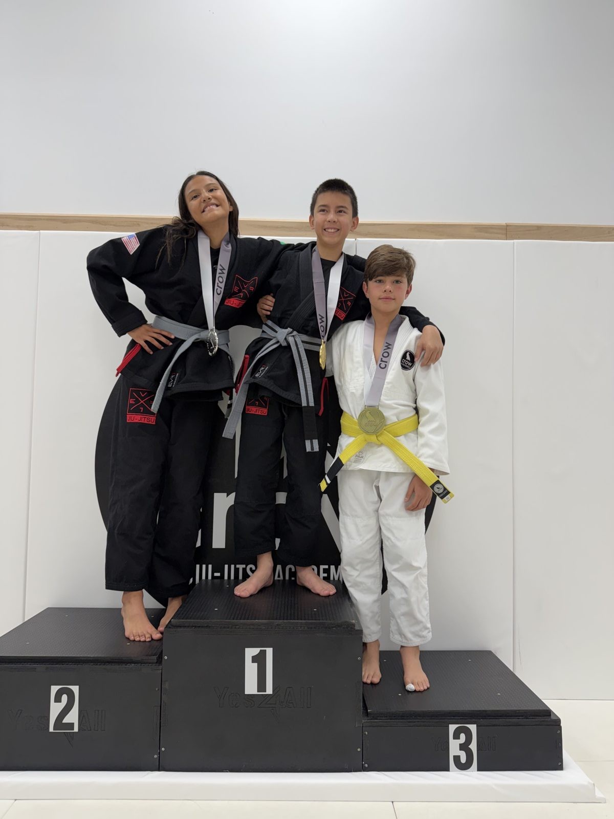EVR1 Kids Jiu-Jitsu students competing at a youth Brazilian Jiu-Jitsu tournament.
