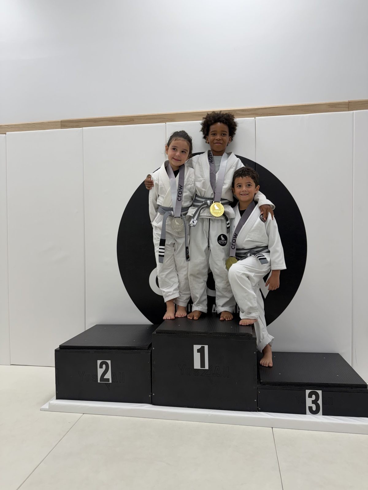EVR1 Kids Jiu-Jitsu students competing at a youth Brazilian Jiu-Jitsu tournament.