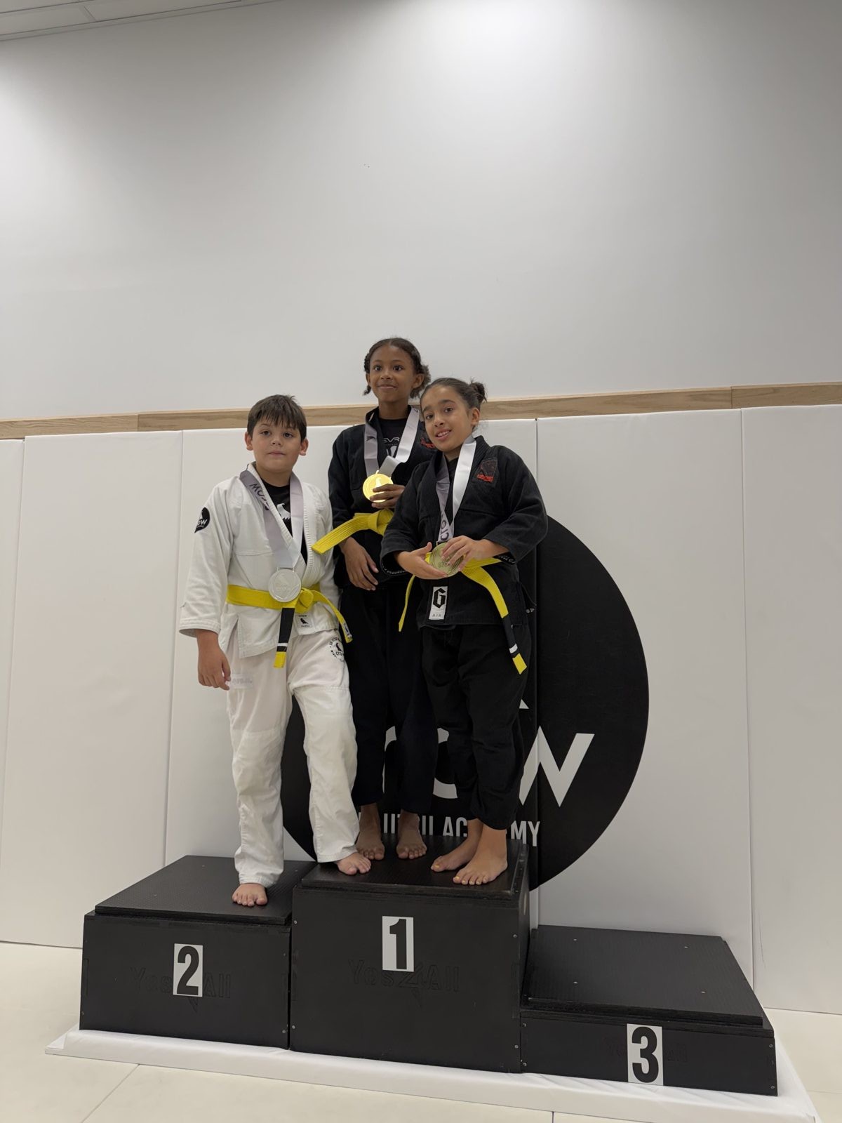 EVR1 Kids Jiu-Jitsu students competing at a youth Brazilian Jiu-Jitsu tournament.