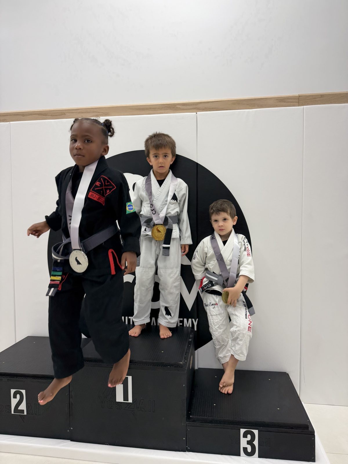 EVR1 Kids Jiu-Jitsu students competing at a youth Brazilian Jiu-Jitsu tournament.