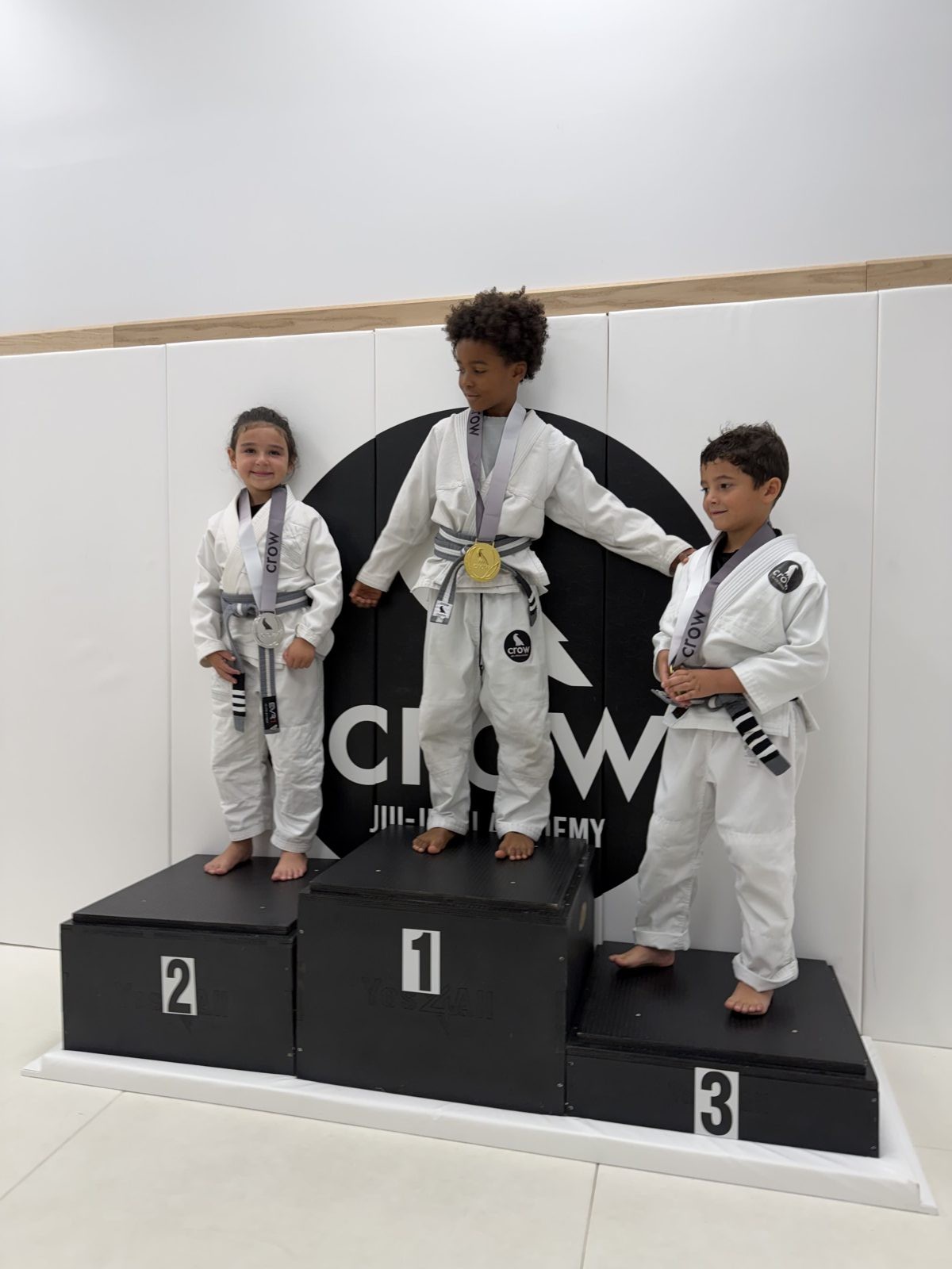 EVR1 Kids Jiu-Jitsu students competing at a youth Brazilian Jiu-Jitsu tournament.