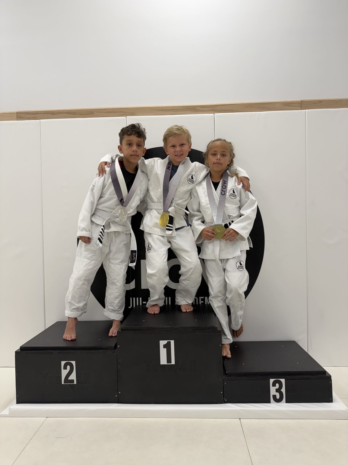 EVR1 Kids Jiu-Jitsu students competing at a youth Brazilian Jiu-Jitsu tournament.