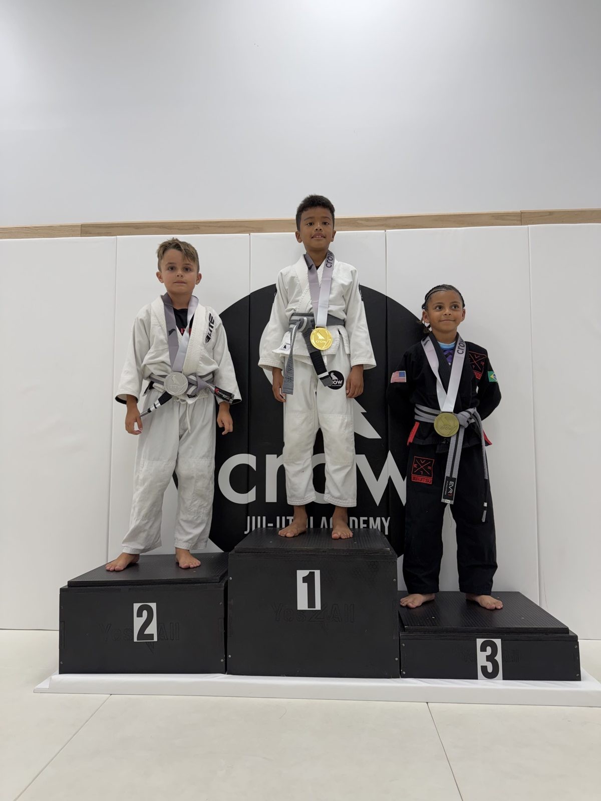 EVR1 Kids Jiu-Jitsu students competing at a youth Brazilian Jiu-Jitsu tournament.